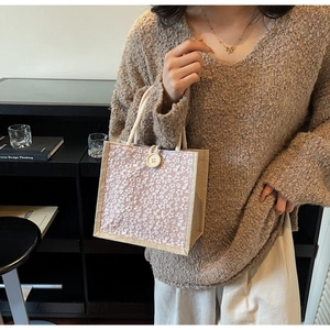 Detail of pink linen lunch bag with 3D flower embroidery and rope handle