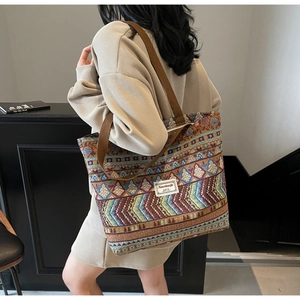 Close-up of ethnic tote bag with geometric knit patterns and sturdy woven shoulder strap