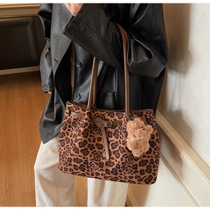 Chic leopard and rose print tote bag with plush bear charm and brown leather straps