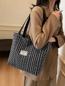 Ethnic style black and white woven tote bag with geometric diamond patterns for women