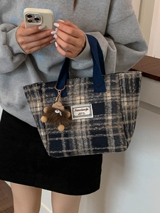 Classic checkered wool shoulder tote bag with brown plush monster charm and blue woven handles