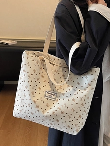 Chic beige corduroy tote bag with heart and bow patterns shown from a 45-degree angle