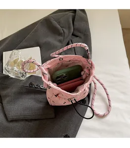 Top view of pink quilted bucket bag showing spacious interior with phone and wallet