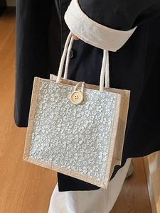 Linen bento tote bag with light blue floral pattern and wood button closure