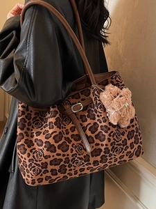 Retro leopard print tote bag with rose pattern and cute puppy charm on a model