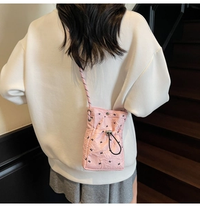 Pink quilted mini drawstring crossbody phone bag with black rabbit pattern detail