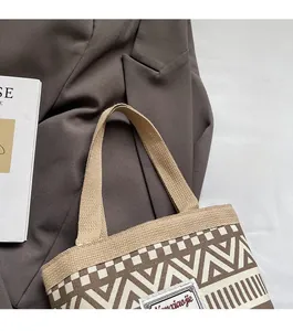 Detail of canvas bucket bag featuring vintage geometric patterns and sturdy handles