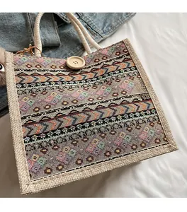 Detailed view of bohemian woven linen handbag with geometric patterns and rope handle