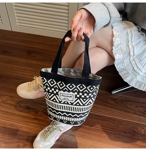 Detail view of the bohemian canvas bucket bag with geometric patterns and beige fabric label