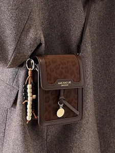 Fashionable leopard print mini phone bag with leather trim and wooden bead charm strap