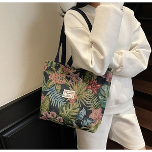 Close-up of durable woven canvas tote featuring vintage tropical monstera and floral patterns