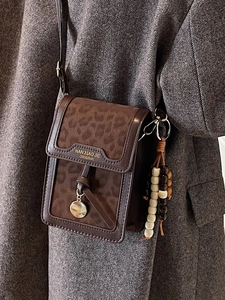 Fashionable leopard print crossbody bag with vintage suede texture and beaded charm