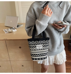 Detail of canvas bucket bag featuring black and white bohemian geometric patterns