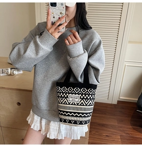 Close-up of ethnic style canvas bucket bag featuring black and white geometric pattern