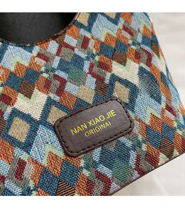 Detailed macro view of woven colorful geometric pattern and premium leather logo patch