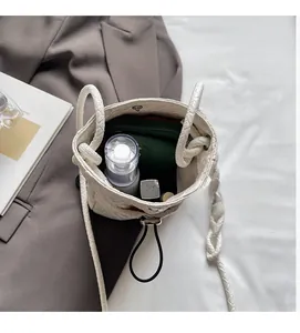 Internal view of a white woven crossbody bag showing capacity for phone and cosmetics
