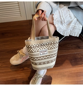 Detail of canvas bucket bag with geometric prints and Nanxiao jie decorative label
