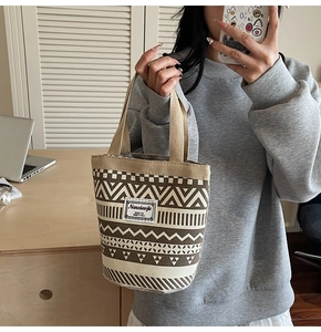 Ethnic style bucket bag with geometric prints shown in a lifestyle mirror selfie view