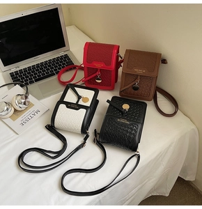 Flat lay of small quilted crossbody phone bags in red, brown, and black with woven details