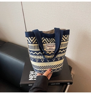 Detail view of ethnic canvas tote bag with navy geometric patterns and sturdy handles