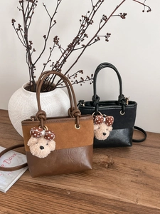 Retro contrast bucket bag with suede paneling, top handle and cute bear charm