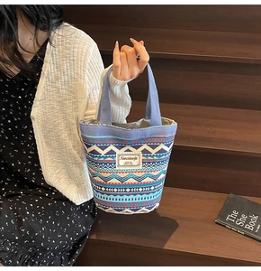 Detailed shot of ethnic canvas tote bag with bohemian pattern and top handle grip