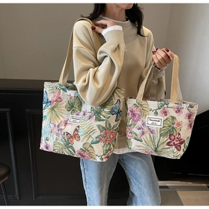 Comparison of large and small floral jacquard tote bags showing size difference