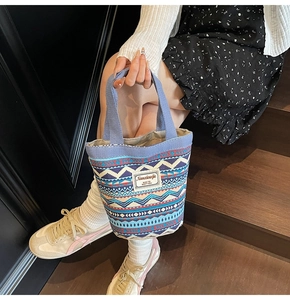 Bohemian canvas bucket bag with colorful geometric patterns shown in a lifestyle setting