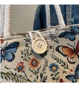 Detail of wooden button closure and floral butterfly pattern on a woven handbag