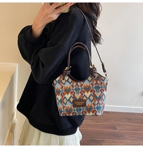 Detailed view of vintage diamond pattern bucket bag with premium leather shoulder straps