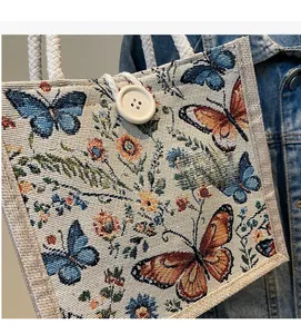 Detail of floral butterfly embroidery on retro linen tote bag with cotton rope handles