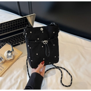 Detail of floral nylon crossbody bag with drawstring closure and thick rope strap