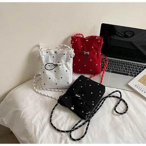 Detailed trio of floral drawstring crossbody bags in white, red and black colors