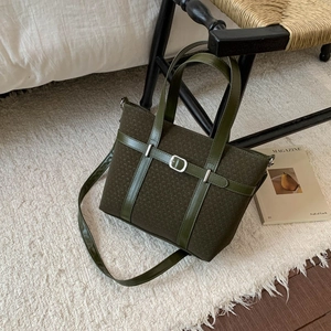 Detail of olive green woven tote bag with smooth faux leather trim and metallic buckle
