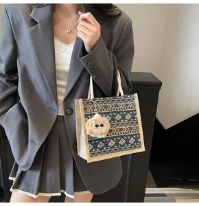 Ethnic geometric tote bag detail featuring colorful woven patterns and plush monster charm