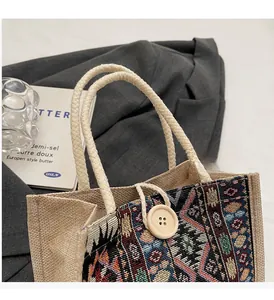 Close-up of bohemian jute handbag with woven patterns and wooden button detail