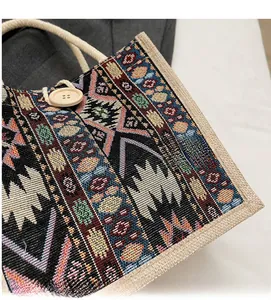 Detail of ethnic jacquard tote bag with bohemian pattern and wooden button closure