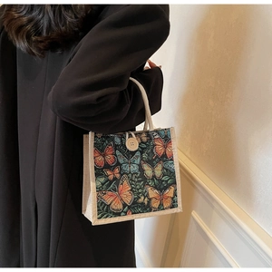 Detailed view of linen tote with floral butterfly pattern and rustic wooden button