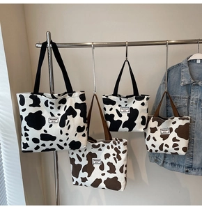 Detailed comparison of four cow print tote bags in black, brown, and two sizes