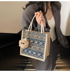 Ethnic woven tote bag detail showing colorful patterns and plush monster charm