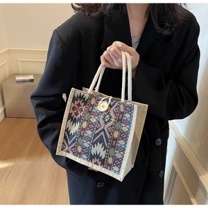 Detailed view of bohemian canvas handbag featuring geometric patterns and cotton rope handle