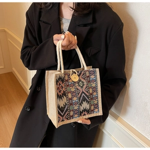Close-up of ethnic patchwork tote bag with colorful geometric patterns and wood button