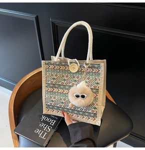 Detail of bohemian linen tote bag with colorful ethnic jacquard and white rope handle