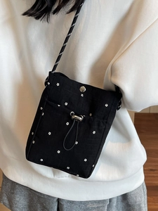 Floral print crossbody bag for women with black woven strap and drawstring detail