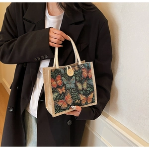 Close-up of linen tote bag with woven butterfly pattern and cotton rope handles