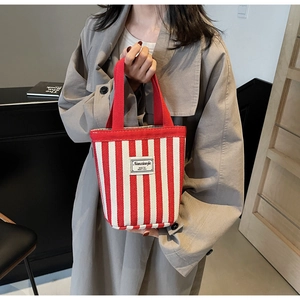 Detail of red and white striped canvas tote bag with top handle for daily use