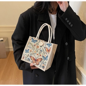 Detailed view of linen tote bag with butterfly embroidery and cotton rope handle