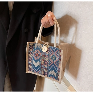 Close-up of ethnic jute tote bag with bohemian pattern and wooden button closure