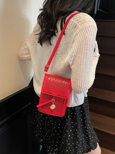 Red woven pattern mini crossbody bag with gold pendant and slim shoulder strap