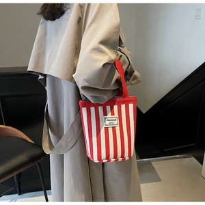 Detail of red and white striped canvas tote bag with Nanxiaojie logo and fabric texture